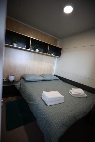 a room with a bed with two towels on it at Ivan in Kalnik