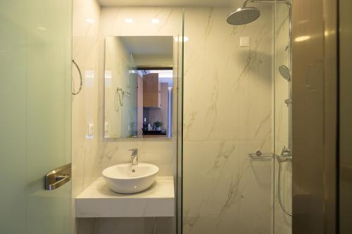 a bathroom with a sink and a glass shower at Falasarna Bay Hotel in Falasarna