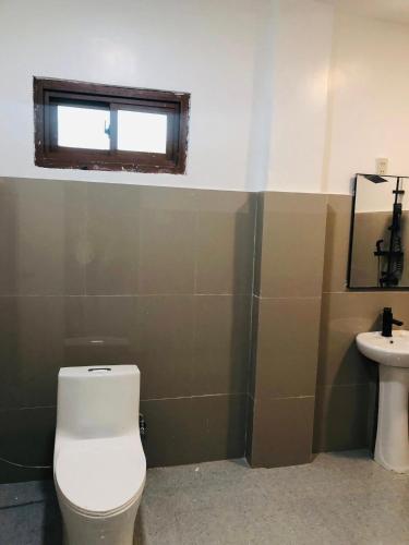 a bathroom with a toilet and a sink at Safe Haven Residence in Talibon
