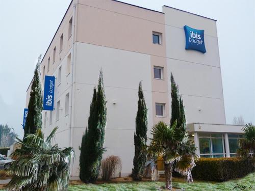 a building with trees in front of it at Ibis Budget Ancenis in Mésanger