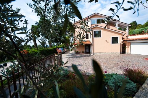 a house with a driveway in front of it at Apartments Portoroz in Portorož