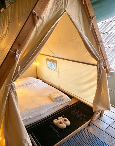 a bed in a tent with two donuts on it at Pont NongKhiaw in Nongkhiaw