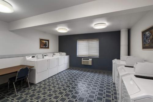 a bathroom with sinks and toilets in a room at Travelodge by Wyndham Gardiner Yellowstone Park North Entr in Gardiner