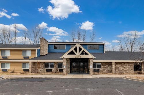 a building with a garage in front of it at AmericInn by Wyndham White Bear Lake St. Paul in White Bear Lake
