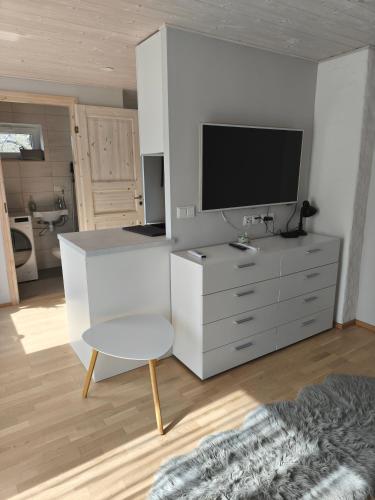 ein Wohnzimmer mit Fernseher und weißer Kommode in der Unterkunft Vabadus in Kärdla