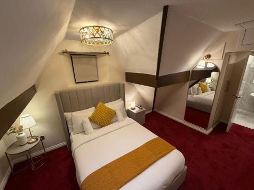 a bedroom with a large bed and a mirror at Milverton Court by OYO in Manchester