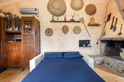 a bedroom with a bed and a fireplace at Villa Anna con giardino in Flussio