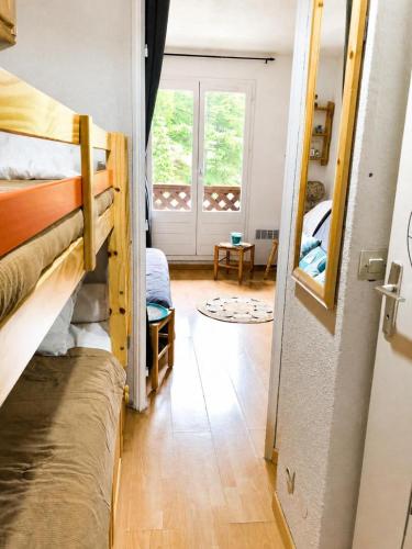 a room with two bunk beds and a window at Cozy studio in La Foux