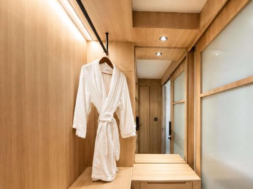 a robe is hanging in a dressing room at Mercure Serpong Alam Sutera in Serpong
