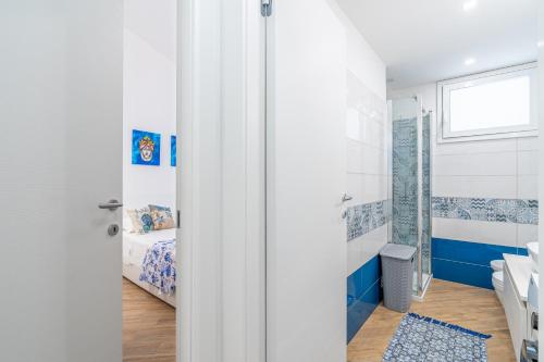 a bathroom with a shower and a bedroom at Casa Mare Vecchio in Avola