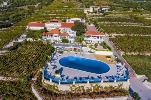 an aerial view of a resort with a large swimming pool at Hotel Pansion Villa Antonio in Orebić