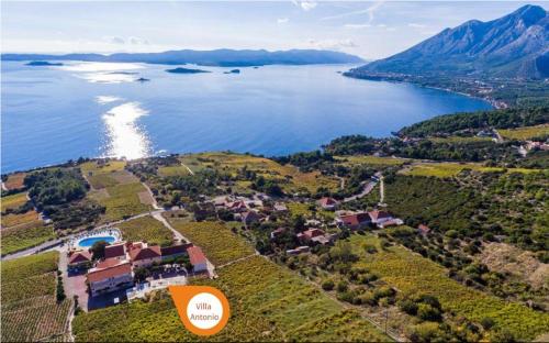 an aerial view of a house next to a body of water at Hotel Pansion Villa Antonio in Orebić