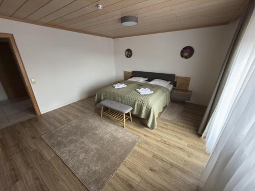 a bedroom with a bed and a chair in it at Haus Monica in Bodenmais
