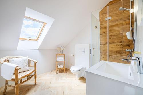 a bathroom with a white sink and a toilet at Dworek Biebrzański in Augustów