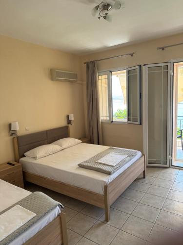 a bedroom with a bed and a large window at Stella Studios in Ilia
