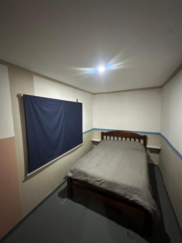 a bedroom with a bed with a large screen on the wall at Quincho y hospedaje in Reconquista