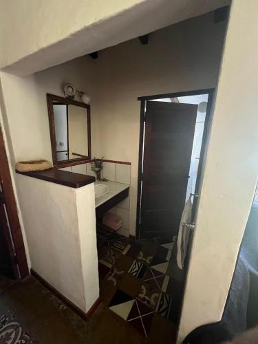 a bathroom with a sink and a mirror at Rest has a name: Munay in Tafí del Valle