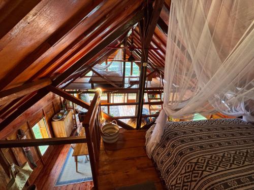 an overhead view of a bedroom in a wooden cabin at Lakey Views Sumbawa in Huu