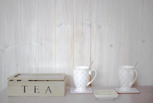 two tea cups and a box on a table at Sunrise Guest House in Bude