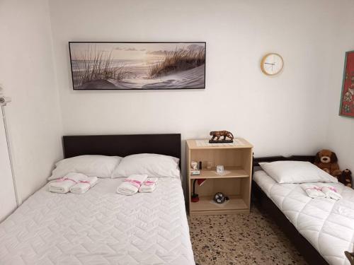 a bedroom with two beds with pink slippers on them at Veranda with Endless View among Orange Trees in Fournés