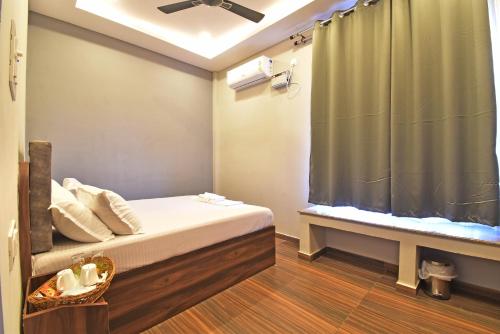a bedroom with a bed with a shower curtain at La Casa d'Auroville in Auroville