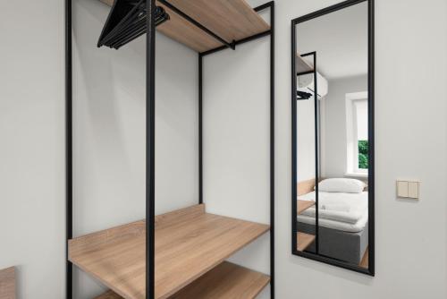 a room with a closet with a mirror at K4 Jonava Rooms in Jonava