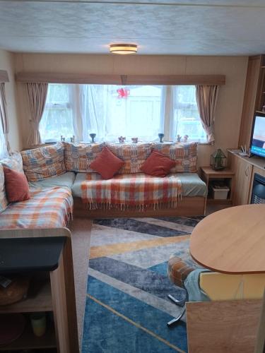 a living room with a couch and a table at 16 Vale Park in Fishguard
