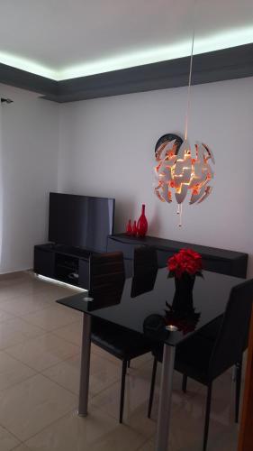 a dining room with a table and a chandelier at Nandy's home in Odza II