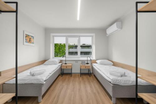 a hospital room with two beds and a window at K4 Jonava Rooms in Jonava