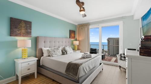 a bedroom with a bed with a view of the ocean at Laketown Wharf 809 in Panama City Beach