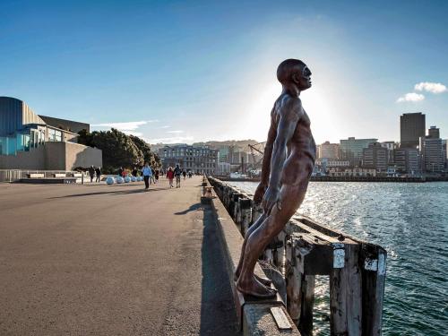 a statue of a man standing on a pier at Mantra Central Wellington in Wellington