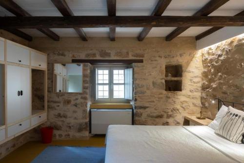 a bedroom with a white bed and a window at Olive Press 1816 in Riglia