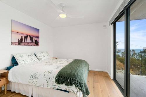 a bedroom with a bed and a large window at Gums & Ocean Hideaway at Wye in Wye River