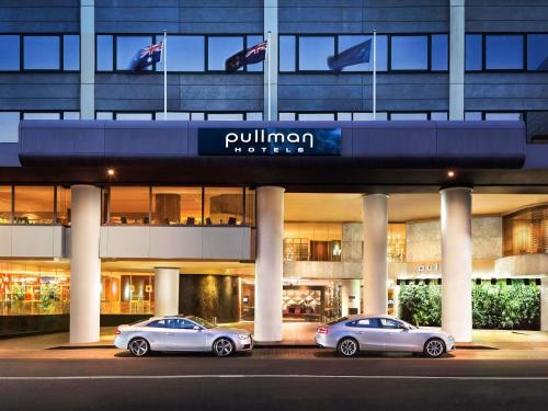 three cars parked in a parking lot in front of a building at Pullman Sydney Hyde Park in Sydney