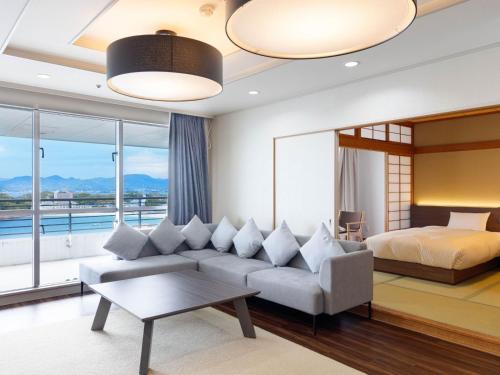 a living room with a couch and a bed at The Gran Resort Elegante Shirahama in Shirahama