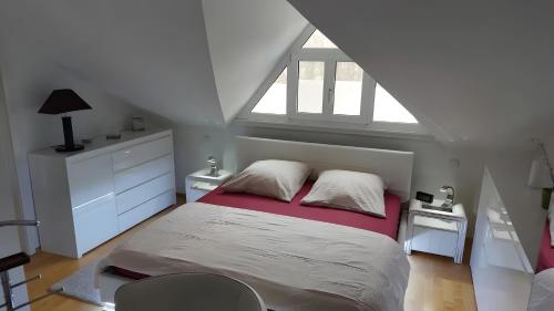 a bedroom with a large bed with a window at Villa-Mainaue in Maineck
