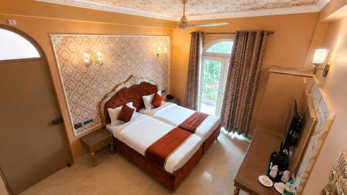 a bedroom with a bed and a large window at Ray of Maya near to taj mahal in Agra