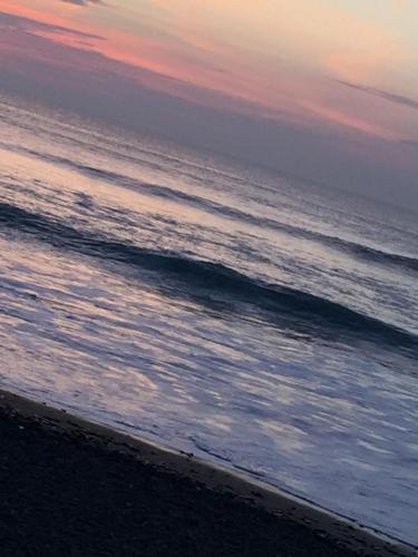 a view of the ocean at sunset at Sunrise Guest House in Bude