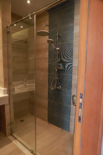 a glass shower in a bathroom with a sink at Miral Resort in Ain Sokhna