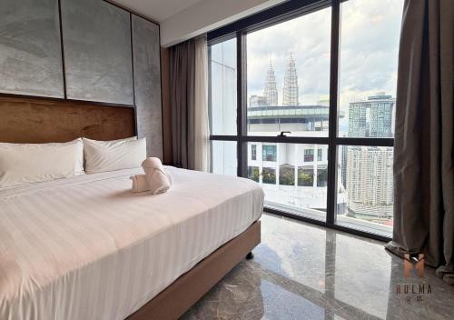 a bedroom with a bed with a teddy bear on it at The Platinum 2 Kuala Lumpur by HOLMA in Kuala Lumpur