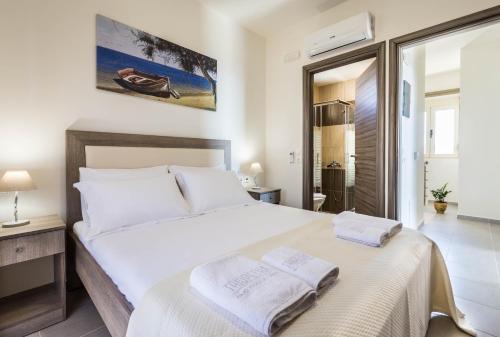 a bedroom with a bed with two towels on it at Villa Lefkopetra in Triopetra