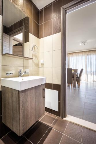 a bathroom with a sink and a dining room at Villa Lefkopetra in Triopetra