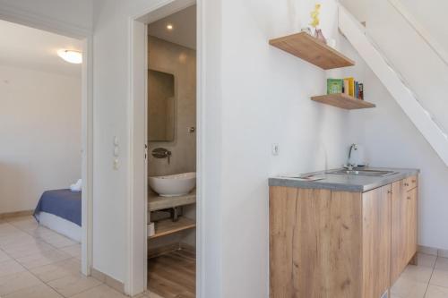 a bathroom with a sink and a sink at Bella Santorini Hotel in Perivolos