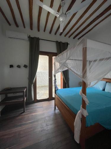 a bedroom with a bed with a canopy at Villa Marisella in Kiwengwa