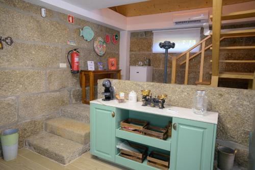 a room with a blue cabinet and some stairs at Casa da Alufinha in São João da Fontoura
