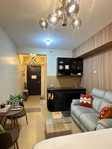 a living room with a couch and a fireplace at JB's Space in Cagayan de Oro