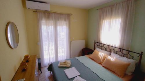 a bedroom with a bed with two towels on it at Teos in Metamorfosi