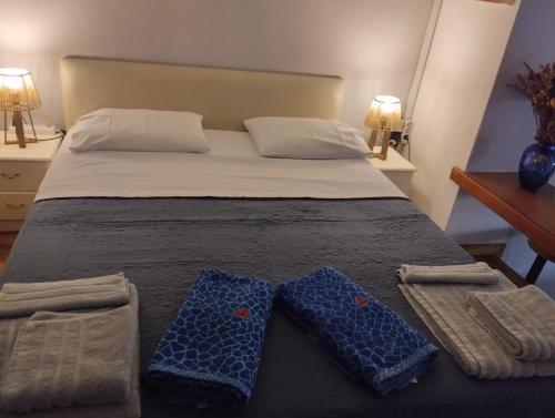 a bedroom with a bed with two towels on it at Studio47 in Athens