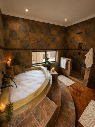 a large room with a large bath tub in a room at Wonderviews Hedgehog in Marloth Park