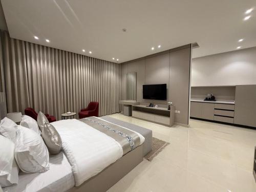 a large bedroom with a large bed and a television at فندق فاليا in Al Kharj